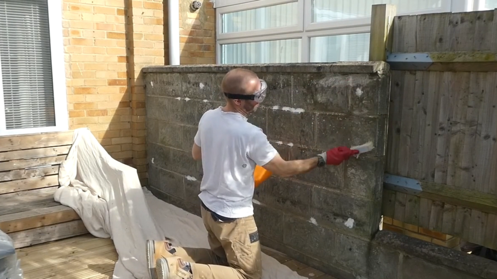Cleaning a masonry wall